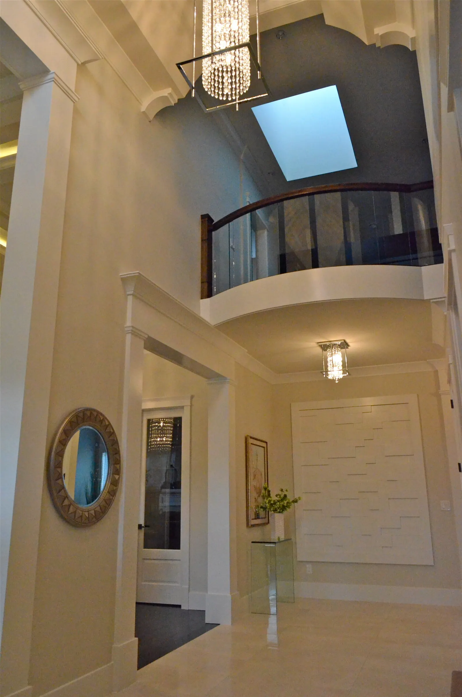 A double-height entry hall lit by a skylight over the upper landing.